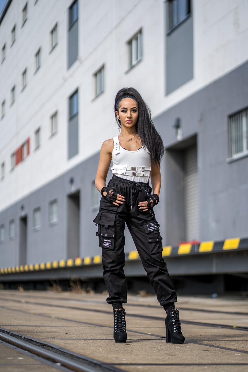 A Woman in White Tank Top and Black Cargo Pants